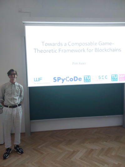 Presenter standing next to a presentation slide Presenter standing next to a presentation slide
